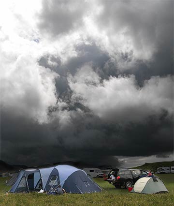 The Bissets pitch tent in a rain-soaked field